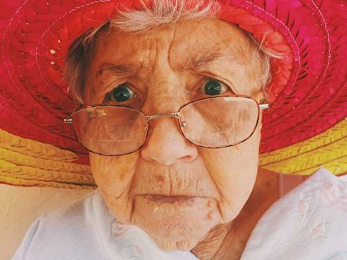face woman in white top wearing eyeglasses person