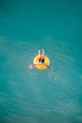 honolulu boy sitting on buoy pool
