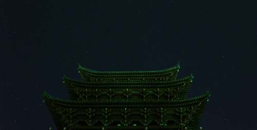 building A building illuminated with green lights. temple