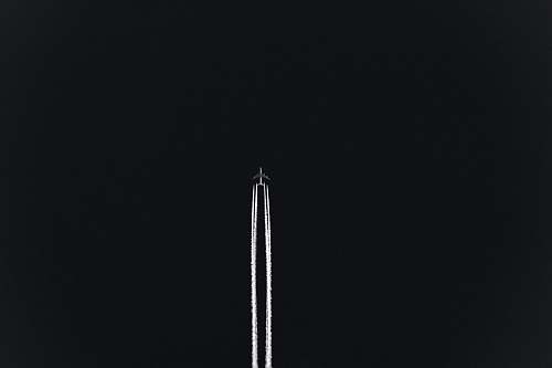 black airplane with white smoke backgrounds