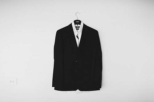 black black suit jacket hanged on wall suit