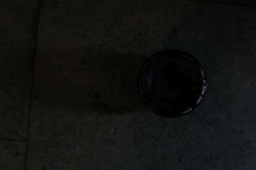 black closeup photography of camera lens on floor tile lens