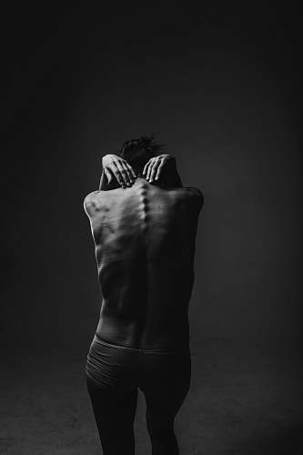 hand grayscale photograph of person reaching to its back black & white