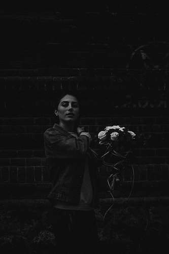 black grayscale photography of woman holding flower bouquet human