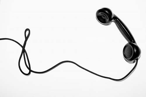 black-and-white black corded telephone white