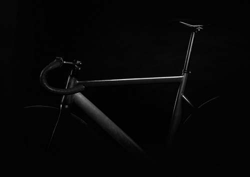black-and-white black road bike on against black background bike