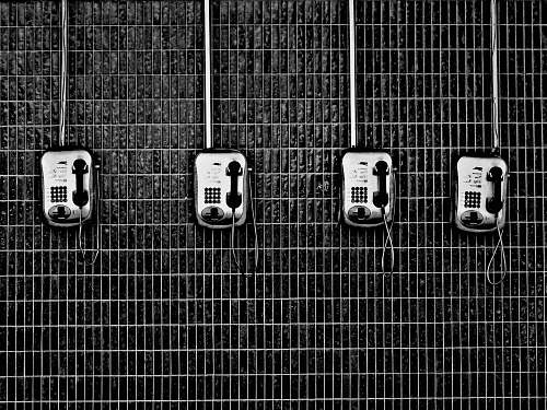 black-and-white four black-and-grey telephones telephone