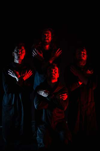 human four men standing with hands on chest person