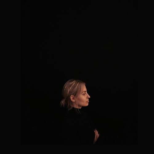 person minimalist photography of woman wearing black top facing to the side human