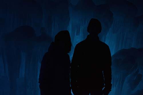 human silhouette of man and woman inside cave person