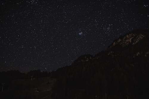 astronomy silhouette photo of mountains night