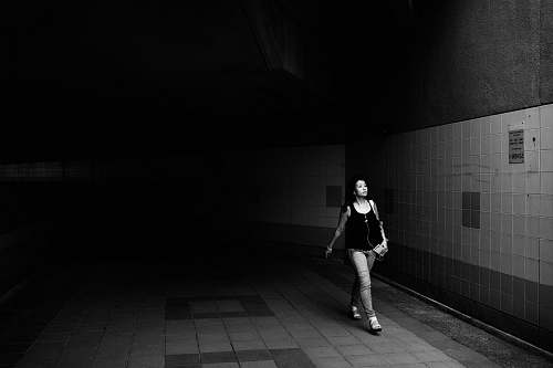 person grayscale photo of girl wearing tank top black-and-white