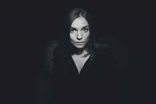 person grayscale photography of woman wearing plunging-neckline top people