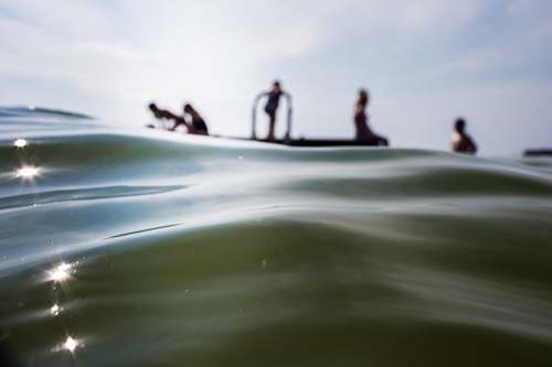 person people on body of water during daytime water