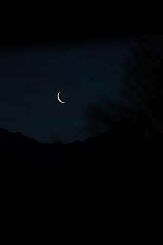 black crescent moon at night outdoors