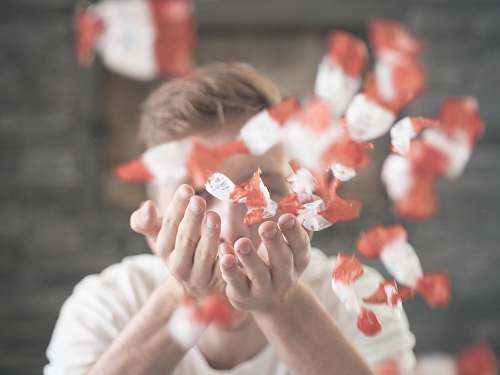 human man scattering flower petals people