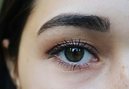 person left human eye in close-up photography contact lens