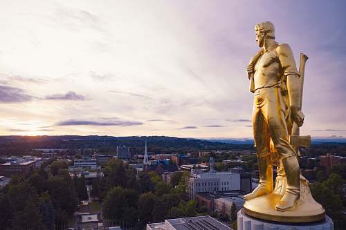 sculpture gold-colored statue during daytime statue