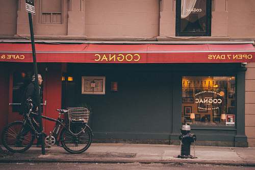 bike man walking in front of Cognac store transportation