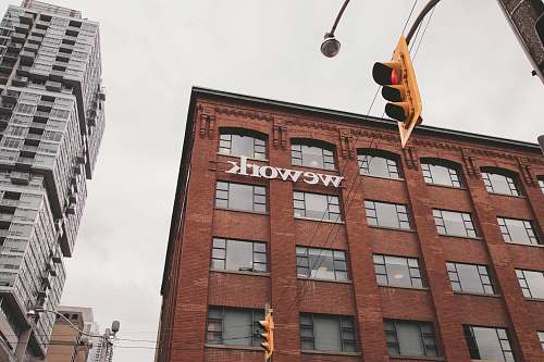 city Wework building beside traffic light during daytime urban