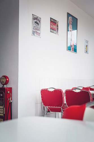 furniture empty chairs beside wall with posters and signs interior design