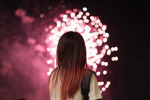 person woman staring at fireworks people