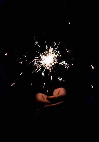 fireworks person holding sparkles outdoors