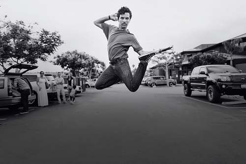 black-and-white grayscale jumping photo of man human