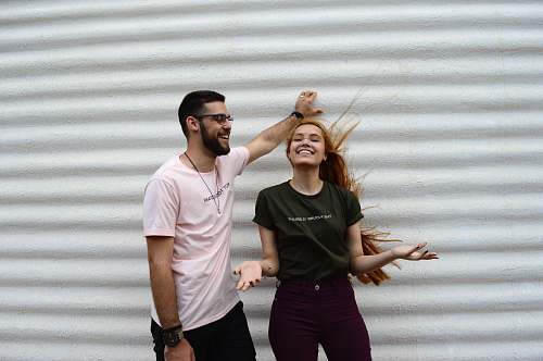 human man and woman standing while chatting apparel