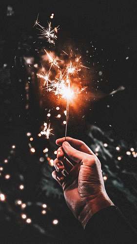 human time-lapse photography of person holding firecracker people