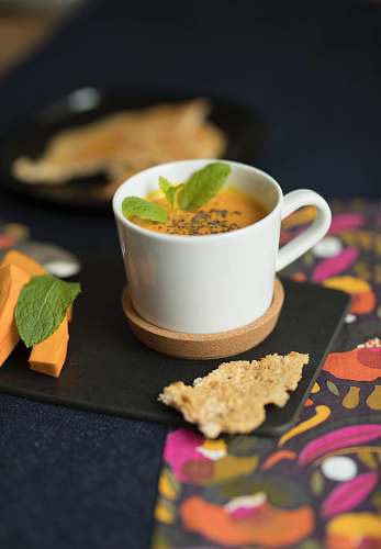 pottery cup of carrot juice with mint on coaster food