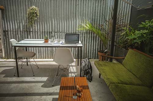 chair laptop computer on top of table flora
