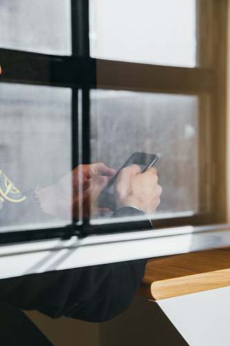 device man holding black Android smartphone meeting